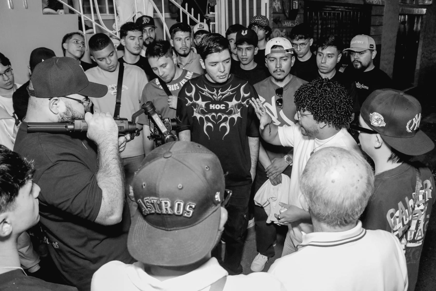 A crowd gathered around a speaker at a community meetup.